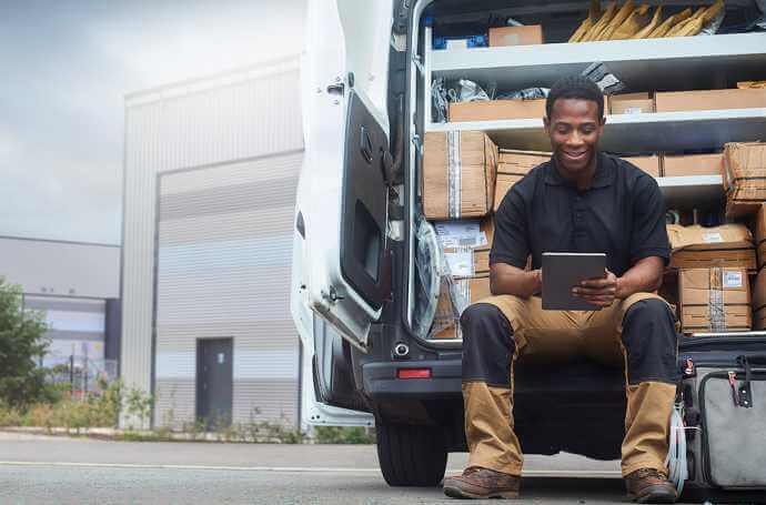 Man sitting in a truck of parcels