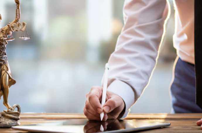 man signing a document