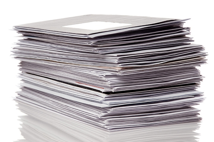 Stack of envelopes and office mail, representing postage meter use for high-volume mailing, postage processing, and mailroom efficiency.