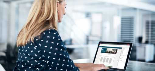 a blond woman working on a laptop showing quadient impress portal a blond woman working on a laptop showing quadient impress portal