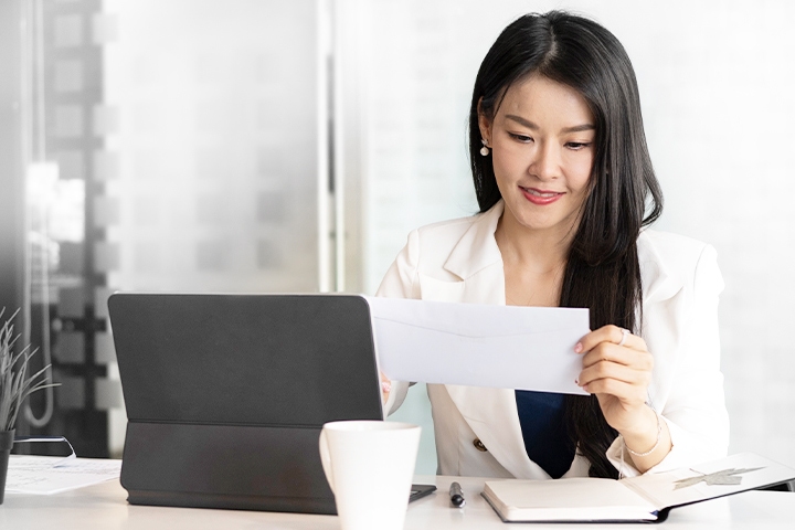 Asian Businesswoman reading mail